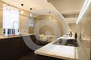 Stylish fitted kitchen with marble counter tops