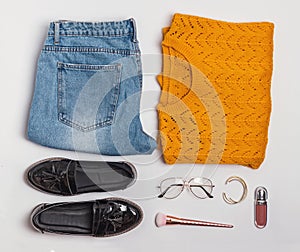 Stylish flat lay with feminine aitumn outfit sweater, jeans and shoes