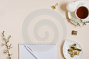 Stylish flat lay for a woman`s fashion blogger. Workplace of a freelancer or office worker: a diary, a pen, a Cup of black tea, a