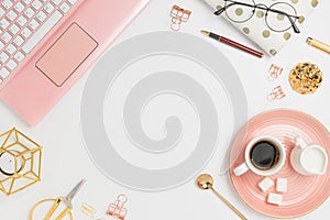 Stylish flatlay frame arrangement with pink laptop, coffee, milk holder, planner, glasses and other accessories