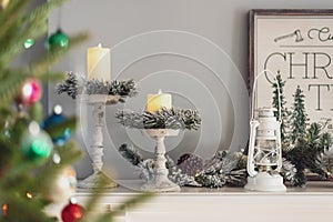 Stylish flocked garland and  candles on the mantel