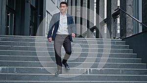 Stylish in formal suit investor middle-aged Asian man businessman boss leader worker walking stepping down stairs