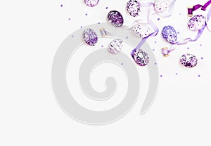 Stylish frame background with easter eggs and silk ribbons. Purple, lilac and white easter eggs with copy space for text. Isolated