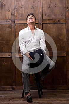 Stylish Frenchman putting his head up while smiling cheerfully