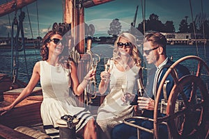 Stylish friends having fun on a yacht