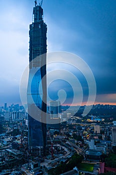 Stylish futuristic building under construction skyscraper KL 118 at sunset rain clouds. Gorgeous views of the landscapes of Kuala