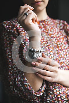 Stylish girl in blouse of flower print , watch, bracelet. Fashion, lifestyle, beauty, clothing.