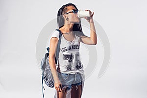 Stylish girl drinking take away coffee disposable