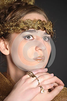 Stylish girl with golden rings