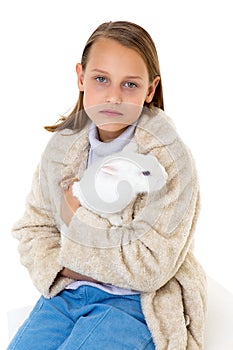 Stylish girl holding white rabbit. Studio portrait.