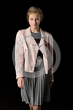 Stylish girl posing against black background. Photo session in the studio