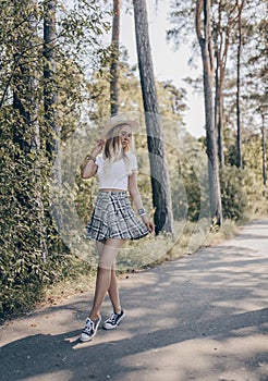 Stylish girl posing in the street, wearing hat. Fashion summer photo photo