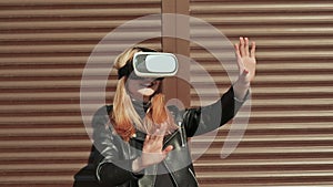 A stylish girl in virtual glasses near horizontal brown curtains.