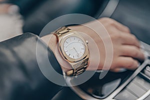 Stylish gold watch on woman hand