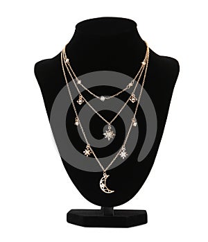 Stylish golden necklace on jewelry bust against white background