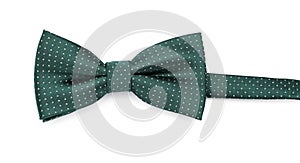 Stylish green bow tie with polka dot pattern on white background, top view