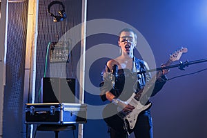 Stylish guitarist playing alternative guitar