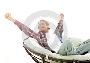 Stylish guy stretching in a comfortable chair