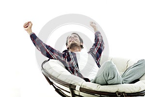 Stylish guy stretching in a comfortable chair