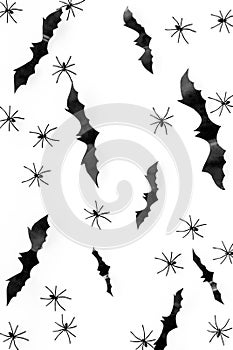 Stylish Halloween design. Bats and spiders on white background top view pattern