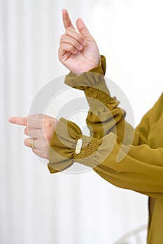 Stylish Hand Gesture and Sleeves Showing The Beautiful Asian Hijab Woman Hand