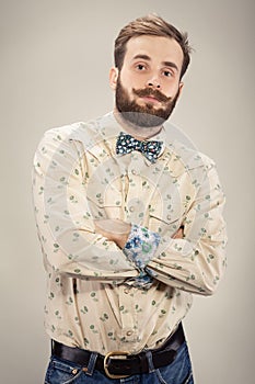 Stylish handsome man with beard and moustache. Portrait male with bow tie