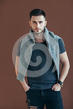 Stylish handsome man portrait on brown background