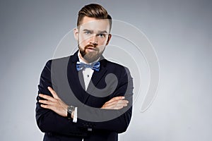 Stylish handsome man wearing a classic suit with bow-tie