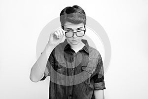 Stylish handsome young man in glasses posing on white background