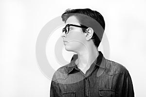 Stylish handsome young man in glasses posing on white background