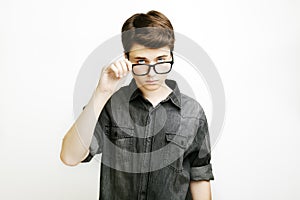 Stylish handsome young man in glasses posing on white background