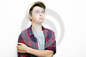 Stylish handsome young man with hat posing on white background