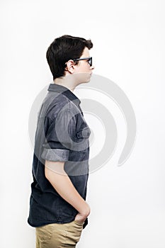 Stylish handsome young man posing in glasses on white background