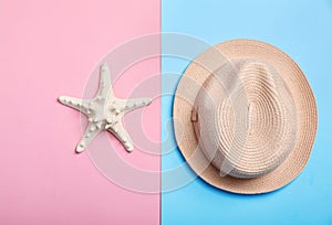 Stylish hat and sea star on color background