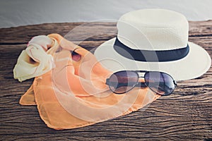 stylish hat woman sunglasses and tablet fashion scarf over wooden table