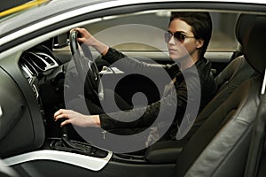 Stylish in her shades and luxury car. A gorgeously stylish woman in shades in her luxury car.