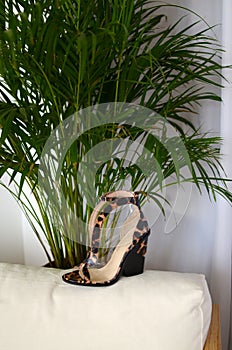 Stylish high heels shoes in animal print design, with high heels shoe in brown suede and with platform sole in wood