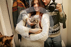 Stylish hipster couple adopted homeless sweet little kitten and