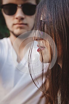 Stylish hipster couple in sunglasses posing and making cool selfie. Happy family couple in love making self portrait and embracing