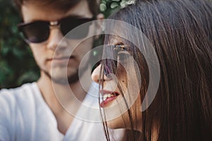 Stylish hipster couple in sunglasses posing and making cool selfie. Happy family couple in love making self portrait and embracing