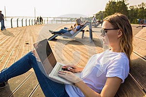 Stylish hipster girl skilled lifestyle blogger working on notebook