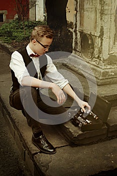 Stylish hipster man holding clarinet and putting it in the case