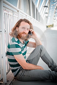 Stylish hipster model with long red hair and beard lifestyle on