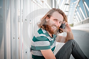 Stylish hipster model with long red hair and beard lifestyle on