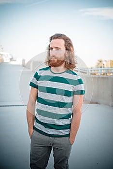 Stylish hipster model with long red hair and beard lifestyle
