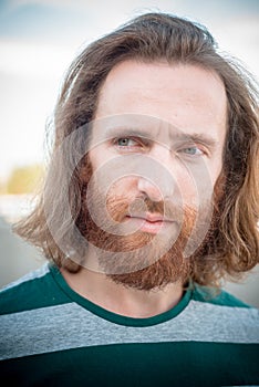 Stylish hipster model with long red hair and beard lifestyle