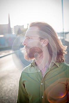 Stylish hipster model with long red hair and beard lifestyle