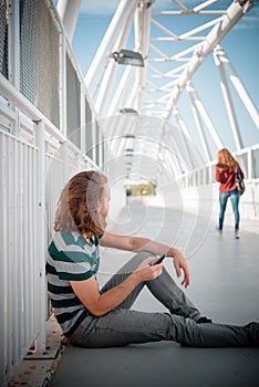 Stylish hipster model with long red hair and beard looking woman