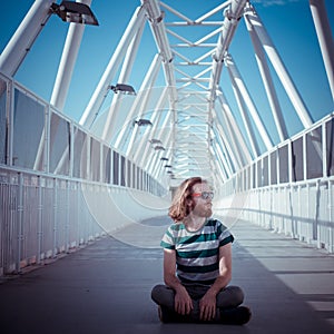 Stylish hipster model with long red hair and beard yoga