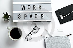 Stylish hipster white desktop top view laptop, coffee, glasses, headphones, pencils, workspace.